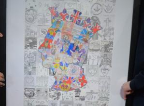 Children present their colourful portrait of King to town
