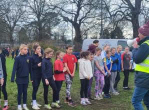 Children run up hill on chilly, soggy Saturday morning... for fun!