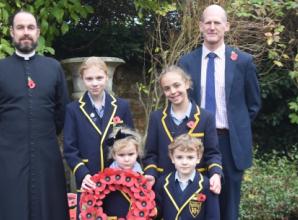 Children taught lesson in forgiveness as they pay tribute with poems and wreaths