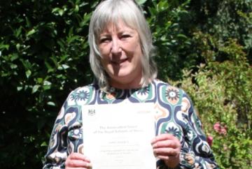 Woman achieves highest award for playing piano