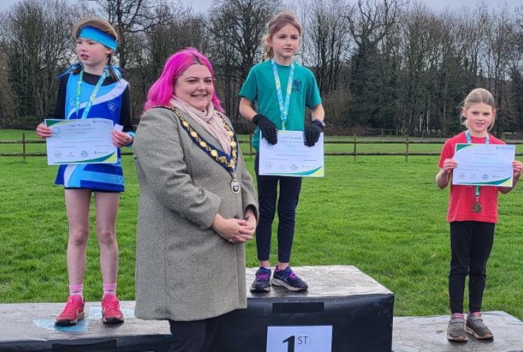 Children run up hill on chilly, soggy Saturday morning... for fun!