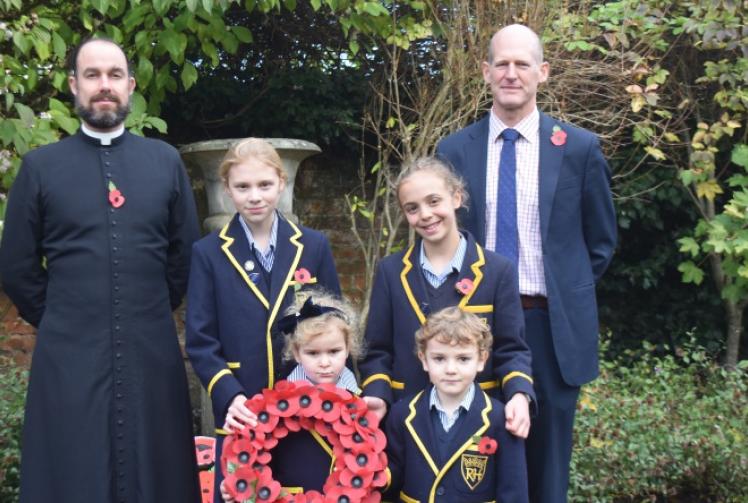 Children taught lesson in forgiveness as they pay tribute with poems and wreaths